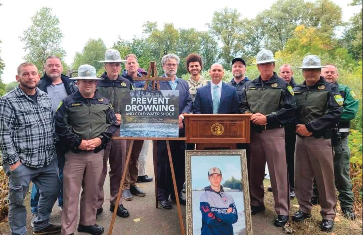 Community leaders, law enforcement and family of Zachary Rager pose for a photo along the Willapa Hills Trail during an event raising awareness around cold water shock to prevent drownings.